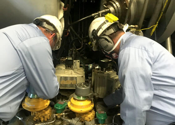 Two EFS technicians making repairs at a university heat plant