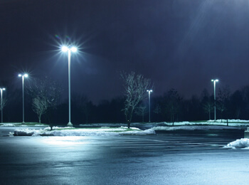 Parking lot at night with snow on the ground